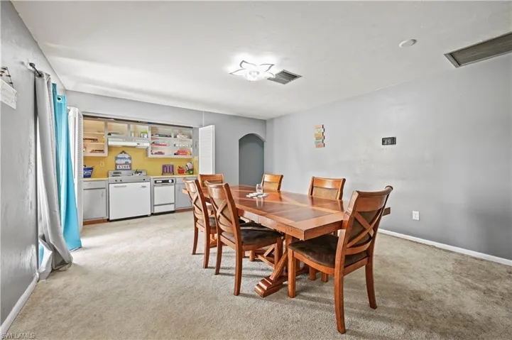 Dining area with light colored carpet