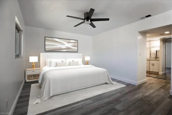 Bedroom featuring ceiling fan, dark wood-type flooring, and a textured ceiling