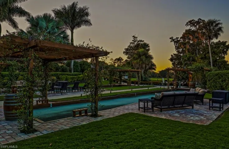 Surrounding community featuring a lawn, an outdoor living space, and a pergola