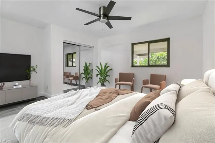 Bedroom with a closet, hardwood / wood-style floors, and ceiling fan