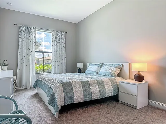 Carpeted bedroom featuring baseboards
