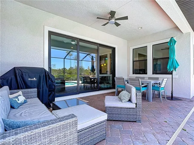 View of patio / terrace with outdoor dining area, a ceiling fan, a pool, and an outdoor living space