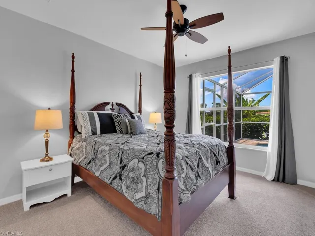 Bedroom with light carpet and a ceiling fan