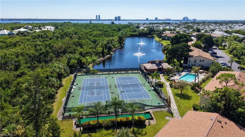 Drone / aerial view of a large body of water and a pool area
