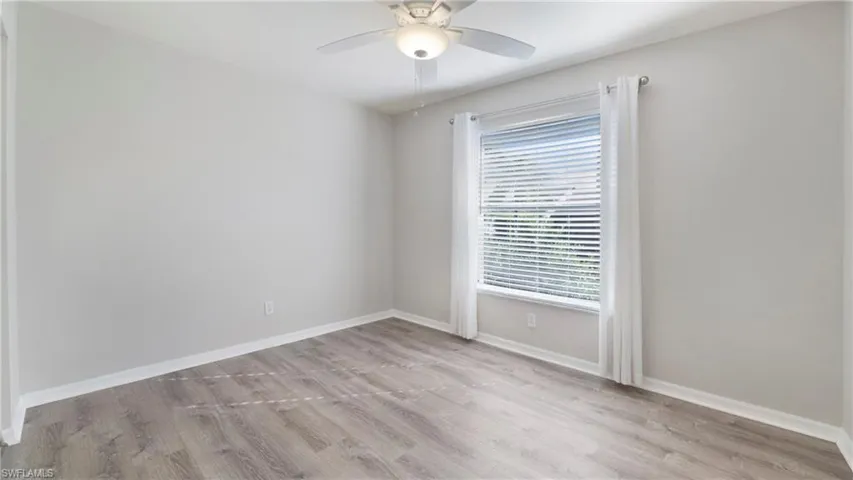 Empty room with light wood-type flooring and ceiling fan