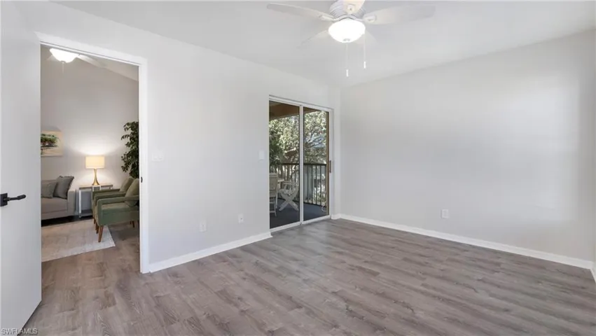 Spare room with a ceiling fan and wood finished floors