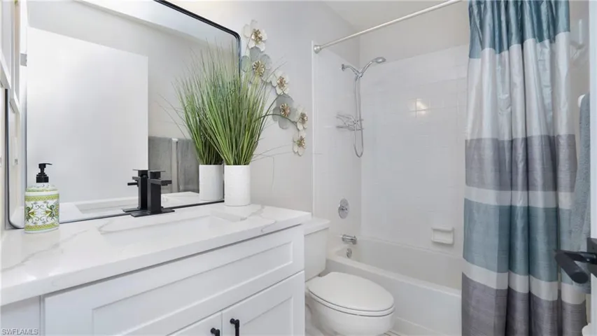 Full bath with vanity and shower / bath combo with shower curtain