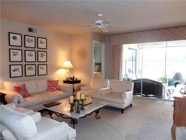 Living area with carpet flooring and a ceiling fan