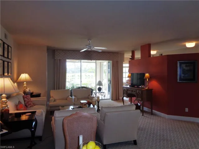 Living room featuring carpet floors and ceiling fan