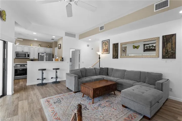 Living room featuring ceiling fan and light hardwood / wood-style floors