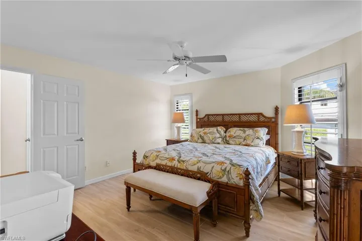Bedroom with light hardwood / wood-style floors and ceiling fan