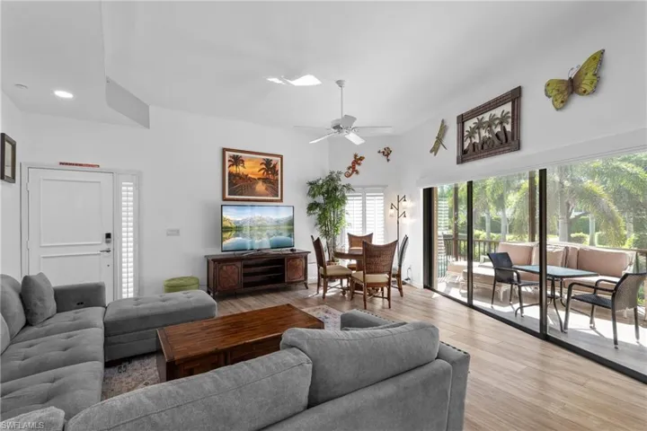 Living room with ceiling fan and light wood-type flooring
