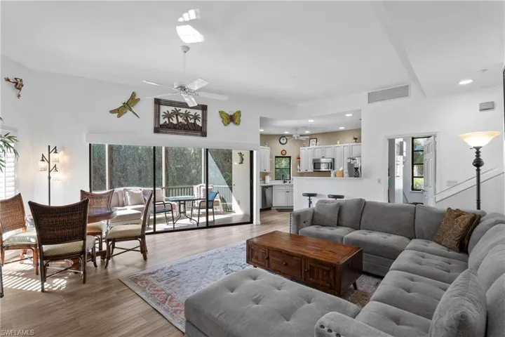 Living room with ceiling fan and wood-type flooring