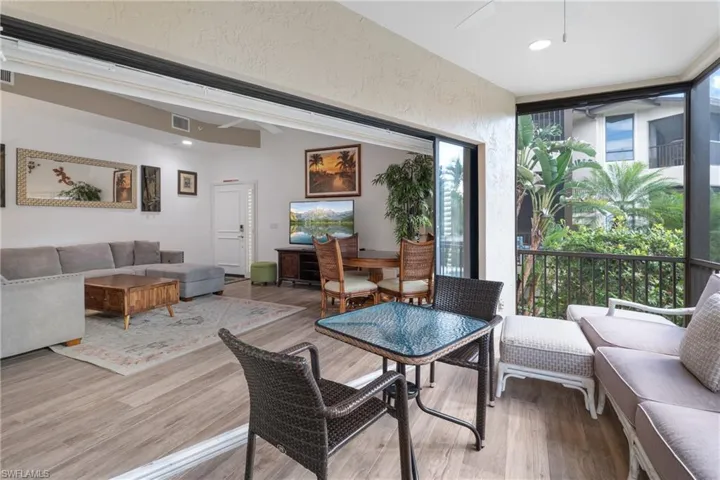 Dining space featuring hardwood / wood-style floors, expansive windows, and a healthy amount of sunlight