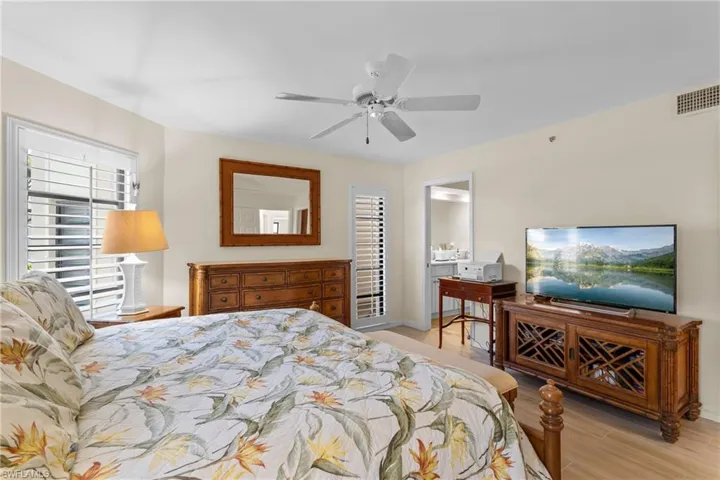 Bedroom with ceiling fan and light hardwood / wood-style flooring