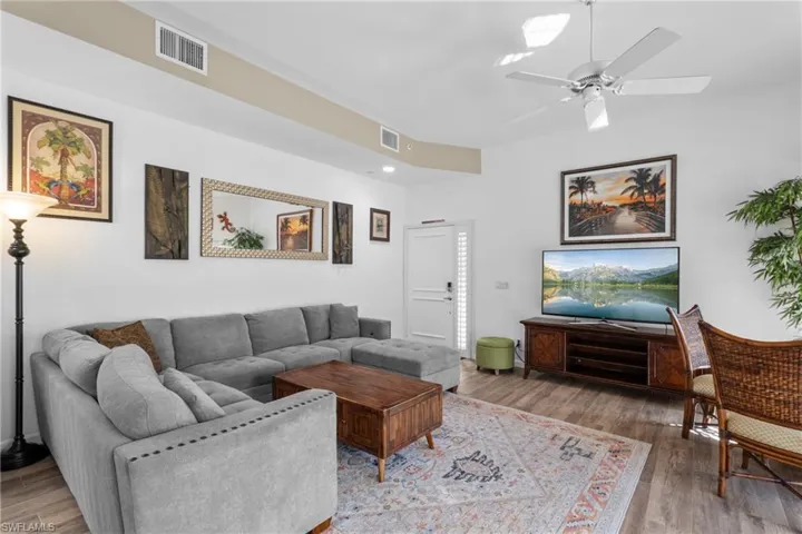 Living room featuring ceiling fan and hardwood / wood-style flooring