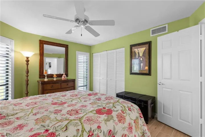 Bedroom featuring ceiling fan, a closet, and light hardwood / wood-style floors