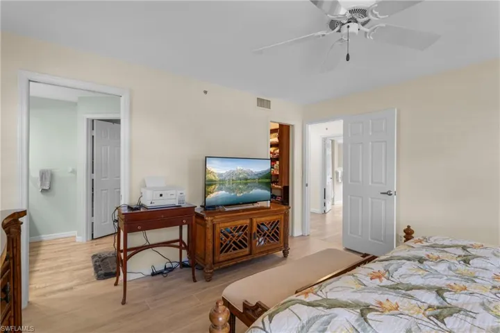 Bedroom with ceiling fan and light wood-type flooring