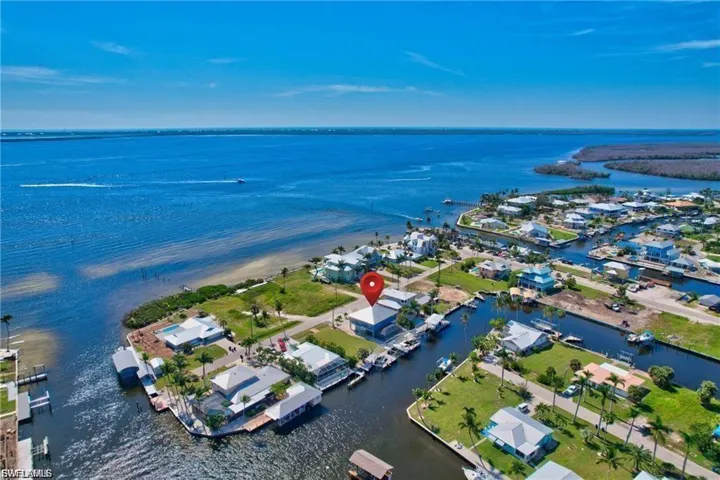 Aerial view of residential area featuring a nearby body of water