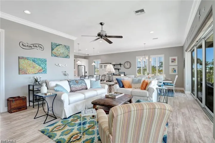 Living room with ornamental molding, light wood-style flooring, a ceiling fan, and recessed lighting