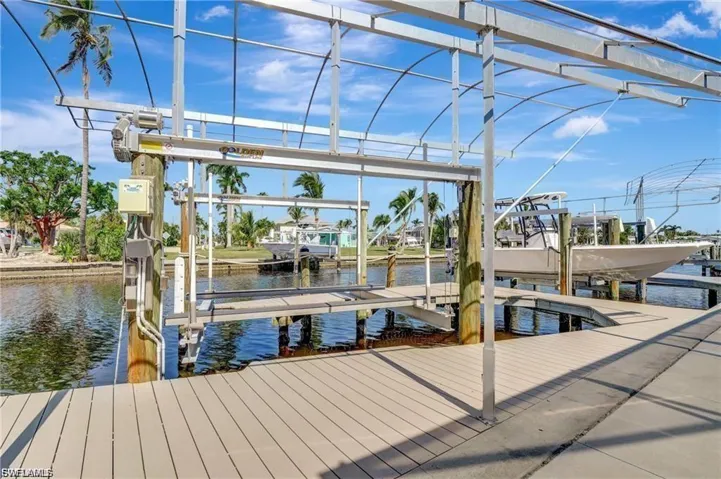 Dock area with boat lift and a water view