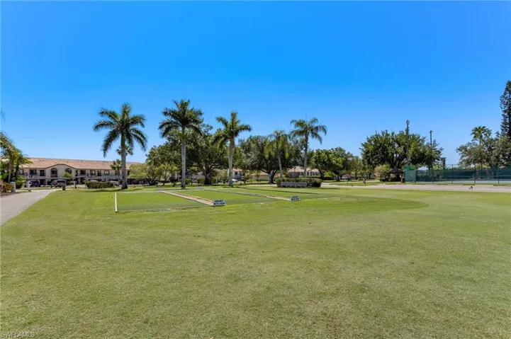 View of home's community with a lawn