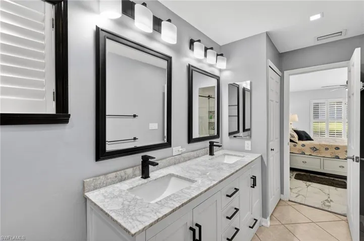 Bathroom featuring double vanity and ensuite bath