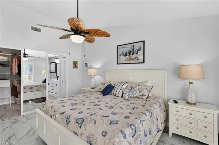 Bedroom featuring light marble finish flooring, a closet, and ceiling fan