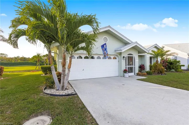 Single story home with a front lawn, concrete driveway, stucco siding, and a garage