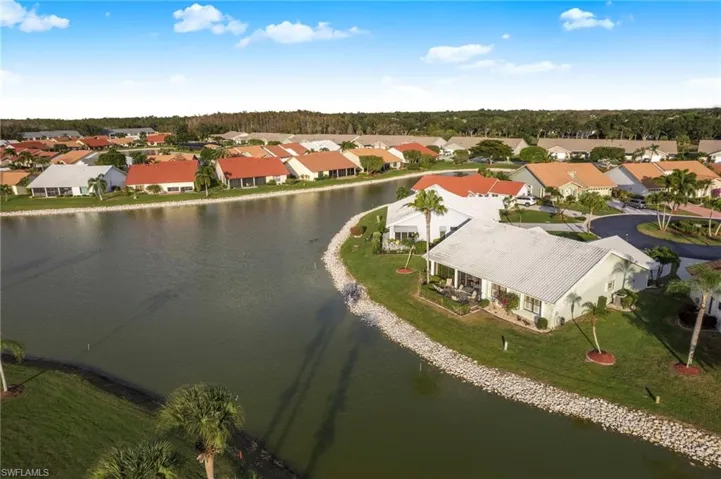 Aerial perspective of suburban area with a nearby body of water