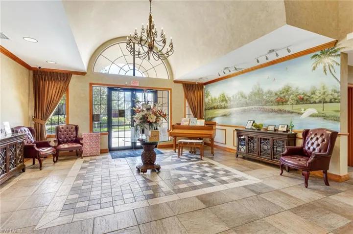 Building lobby with vaulted ceiling, a water view, recessed lighting, and crown molding