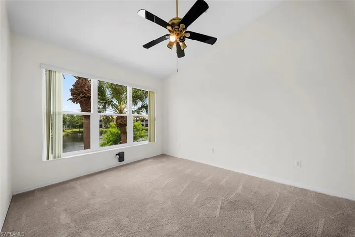 Spacious room with vaulted ceilings and neutral carpeting