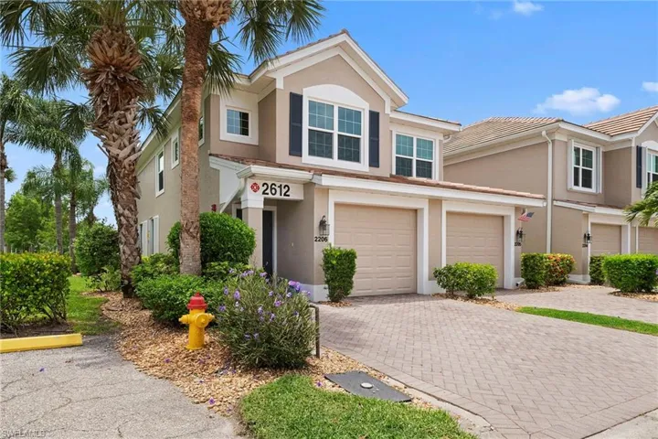 Tan stucco exterior with dark shutters