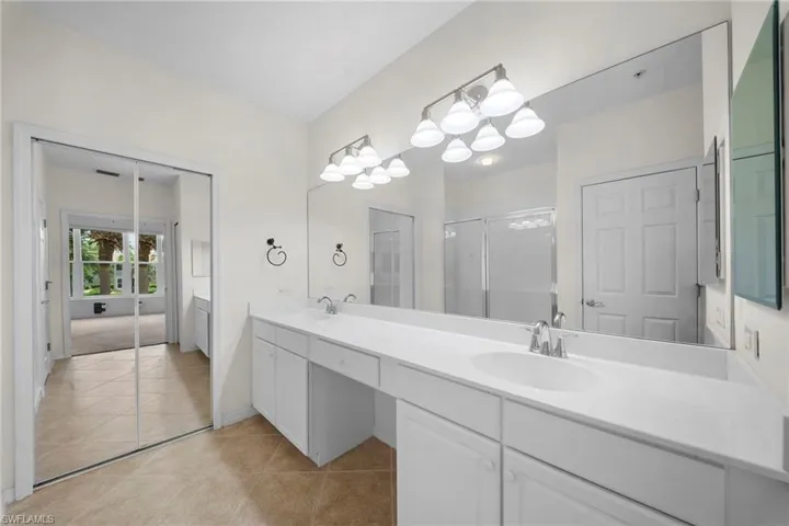 Dual vanity with integrated sinks and white cabinetry