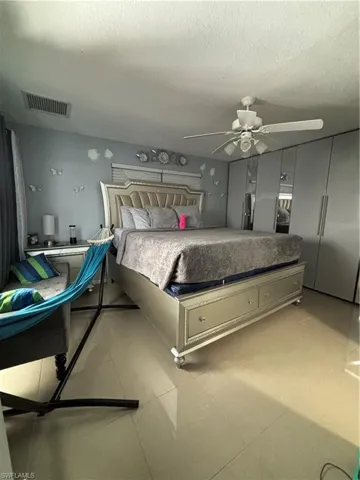 Bedroom featuring a textured ceiling and ceiling fan