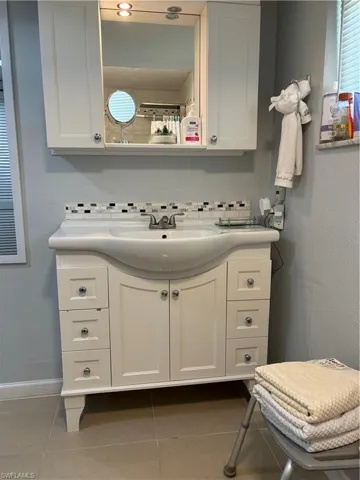 Full bathroom with vanity and tile patterned floors