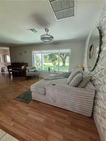 Bedroom with wood finished floors and a textured ceiling