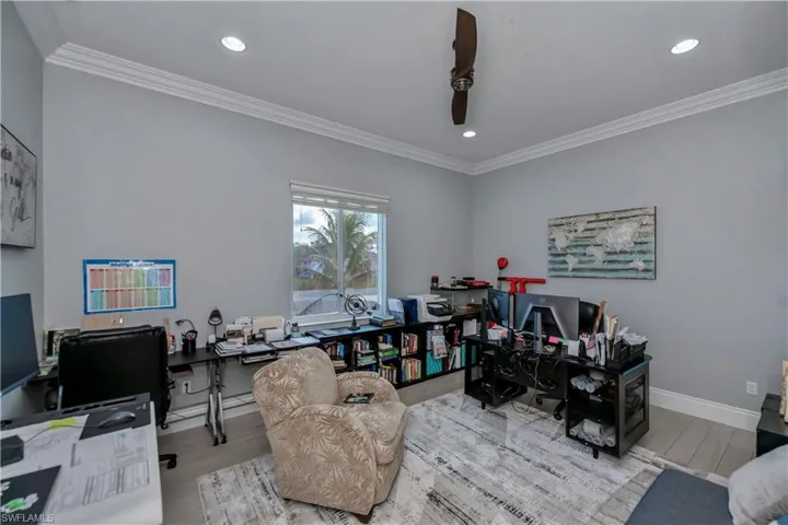 Office with crown molding and light hardwood / wood-style flooring