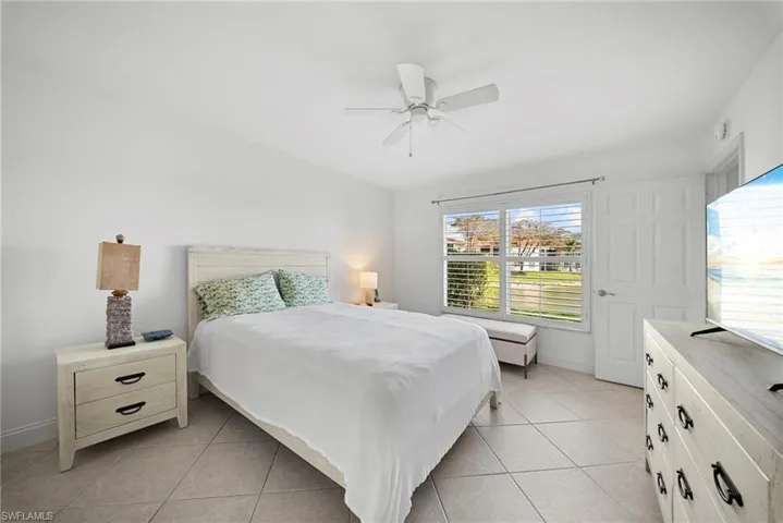 Bedroom featuring light tile patterned flooring and a ceiling fan