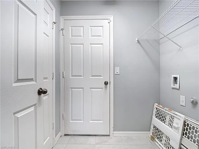 Laundry with large closet for storage or pantry.  Door leads to garage