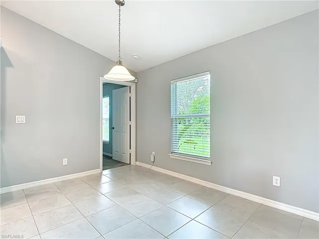 Dining area with doorway to primary bedroom
