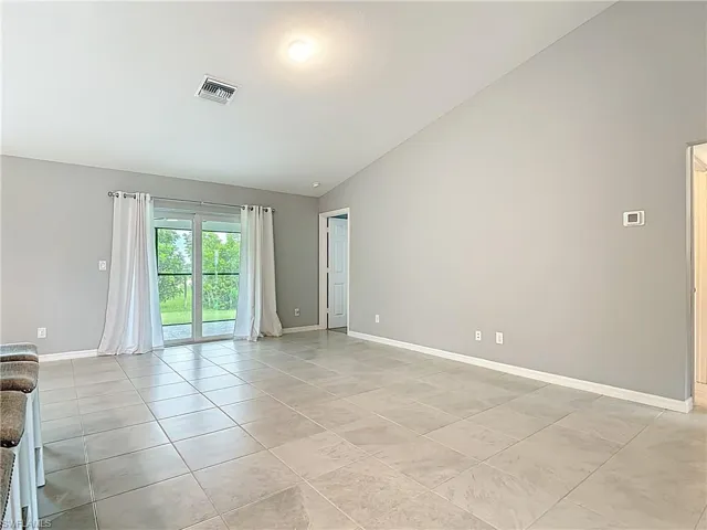 Sliding doors to screened lanai & doorway leads to primary bedroom