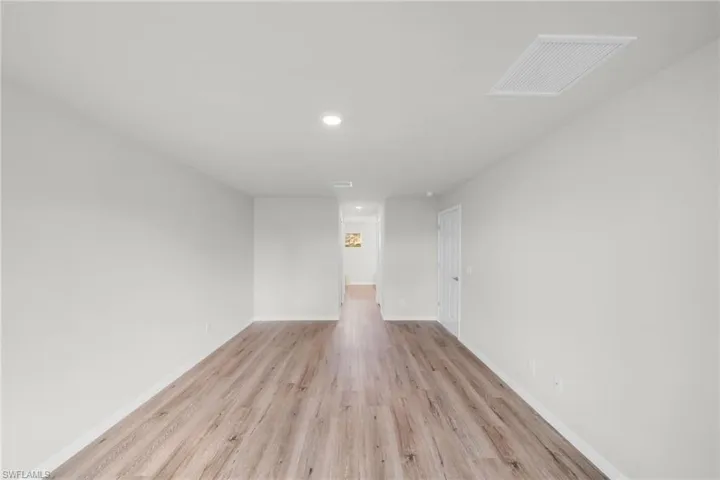 Spare room featuring recessed lighting, baseboards, visible vents, and light wood finished floors