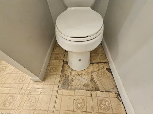 Bathroom with toilet and baseboards