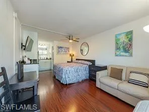 Bedroom with dark wood-style floors and ceiling fan