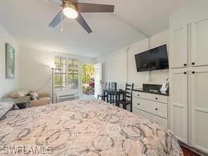 Bedroom featuring ceiling fan and dark wood finished floors