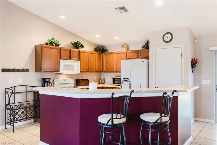 Nice size kitchen with a large island, pantry and a cathedral ceiling