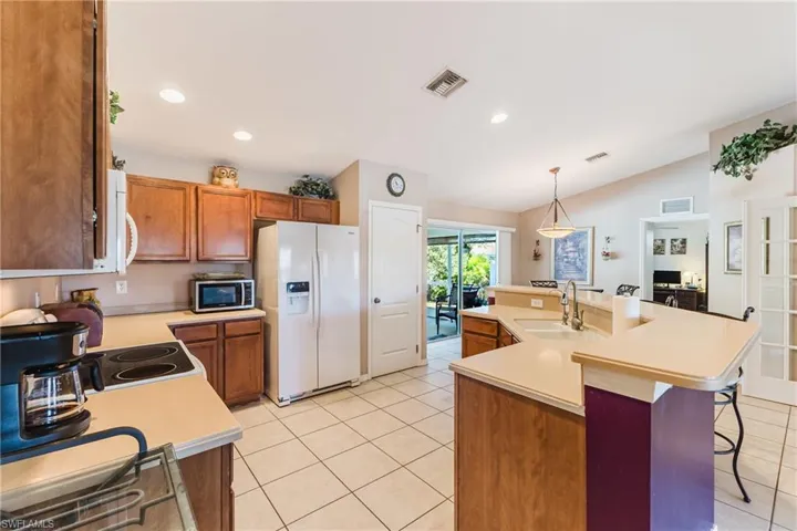 View of kitchen and dining area - plenty of counterspace and cabinets for all your cooking needs!