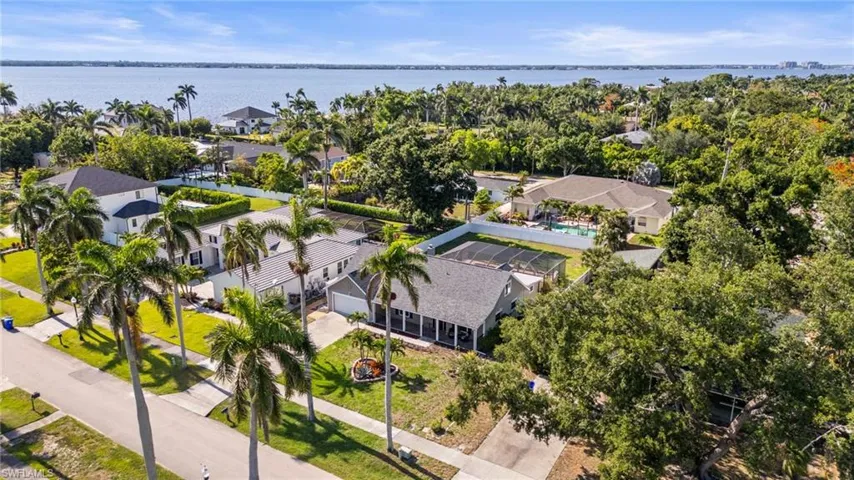 Aerial view of residential area featuring a nearby body of water