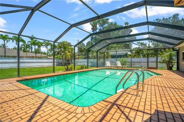 View of swimming pool with a fenced backyard.